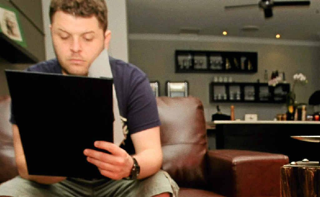 A little too early for a drop, instead Rustic Restaurant and Bar owner Nathan Warner enjoys a coffee while admiring his new menu.